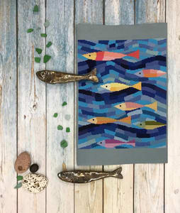 An artistic design of colorful sea fish in blue waves. This modern fish cross stitch pattern uses Anchor cotton colors for better shades of blue.